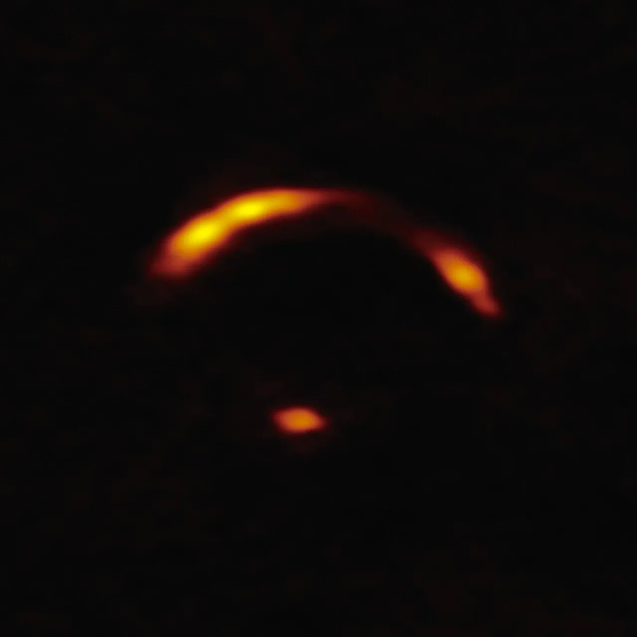 This image shows a close-up of the gravitationally lensed galaxy nicknamed "Shadow Blaster," which astronomers have identified as the likely source of the high-energy neutrino event IC 210922A, detected by the IceCube Neutrino Observatory in 2021.